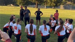 Varsity softball team with coach Kevin Bella